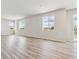 Spacious, airy living room with large windows overlooking green fields and modern vinyl plank flooring at 42754 Calusa Pines Rd, Elizabeth, CO 80107