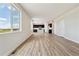 Open living room and kitchen with plank floors, bright light and modern dark cabinets at 42754 Calusa Pines Rd, Elizabeth, CO 80107