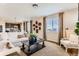 Open concept living room with an adjacent kitchen area, large windows, and stylish decor at 42754 Calusa Pines Rd, Elizabeth, CO 80107