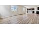 Open living room and kitchen with plank floors, bright light and modern dark cabinets at 42754 Calusa Pines Rd, Elizabeth, CO 80107