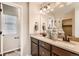 Modern main bathroom featuring dual sinks, ample counter space, dark wood cabinetry and a separate toilet room at 42754 Calusa Pines Rd, Elizabeth, CO 80107