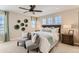 Spacious main bedroom boasts a ceiling fan, large windows and a decorative wall art installation at 42754 Calusa Pines Rd, Elizabeth, CO 80107