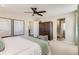 Bright main bedroom showcases stylish decor, a ceiling fan, and ensuite bath and walk-in closet access at 42754 Calusa Pines Rd, Elizabeth, CO 80107