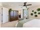 Comfortable main bedroom includes a large armoire, ceiling fan, natural light and ensuite bathroom access at 42754 Calusa Pines Rd, Elizabeth, CO 80107