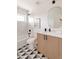 A stylish bathroom features geometric tile floors, modern vanity, and a tub and shower combination at 16133 W 14Th Ave, Golden, CO 80401