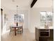 Dining area with modern lighting fixture, wood table, and seating, adjacent to the kitchen at 16133 W 14Th Ave, Golden, CO 80401