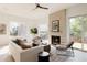 Bright living room with comfortable seating, fireplace, and large windows offering plenty of natural light at 16133 W 14Th Ave, Golden, CO 80401