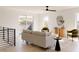 Bright living room with contemporary furniture, hardwood floors, and sliding glass doors leading to an outdoor deck at 16133 W 14Th Ave, Golden, CO 80401