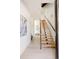 Contemporary staircase with wood steps and black railing, leading to the upper level of the home at 16133 W 14Th Ave, Golden, CO 80401