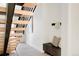 Modern staircase with black railings and light wood stairs, complemented by a decorative bench at 16133 W 14Th Ave, Golden, CO 80401