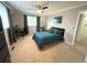 Well-lit bedroom features neutral tones, a ceiling fan, and a workspace, creating a serene and practical atmosphere at 4676 White Rock Cir # 12, Boulder, CO 80301