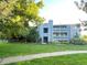 Exterior view of a multi-story condominium building with lush lawn, landscaping and walking path at 4676 White Rock Cir # 12, Boulder, CO 80301