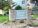 Well-maintained sign for Hunter Creek Condominiums with brick accents and manicured landscaping at 4676 White Rock Cir # 12, Boulder, CO 80301