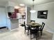 Cozy dining area with a round table and modern light fixture, complemented by an adjacent, functional kitchen at 4676 White Rock Cir # 12, Boulder, CO 80301