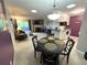 Open-concept living area featuring a fireplace, kitchen with white cabinets, and a comfortable dining space at 4676 White Rock Cir # 12, Boulder, CO 80301