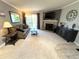 Spacious living room featuring a fireplace, mounted TV, carpet, and comfortable seating with balcony access at 4676 White Rock Cir # 12, Boulder, CO 80301