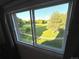 A serene window view overlooking a lush green park with mature trees, offering a peaceful and scenic outlook at 4676 White Rock Cir # 12, Boulder, CO 80301