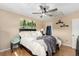 Cozy bedroom includes a ceiling fan, wall art, and plenty of natural light at 8019 Wolff St # A, Westminster, CO 80031