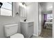 Elegant bathroom with a modern gray vanity, hexagon tile flooring and natural light at 891 Ursula St, Aurora, CO 80011