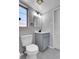 Elegant bathroom featuring a modern gray vanity, hexagon tile flooring, natural light, and stylish fixtures at 891 Ursula St, Aurora, CO 80011