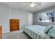 Bright bedroom featuring a ceiling fan, a large window, and vintage wooden dresser at 891 Ursula St, Aurora, CO 80011