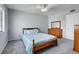 Comfortable bedroom with a wooden bed frame and dresser, with light blue walls and grey carpet at 891 Ursula St, Aurora, CO 80011