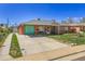The charming exterior features a brick facade and a long driveway at 891 Ursula St, Aurora, CO 80011