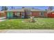 Charming home with a lush green lawn and decorative windmill at 891 Ursula St, Aurora, CO 80011