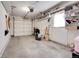 Clean garage interior with overhead storage and shelving, offering ample space for organization and storage at 891 Ursula St, Aurora, CO 80011