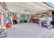 Organized garage with workbench, tool storage, and shelving, providing ample space for projects and storage at 891 Ursula St, Aurora, CO 80011