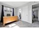 Functional office with neutral walls, plush gray carpet, and a view leading to a half-bathroom and bedroom at 891 Ursula St, Aurora, CO 80011