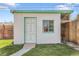 Quaint white storage shed with a green trim and a well-maintained exterior at 891 Ursula St, Aurora, CO 80011