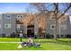 Gray apartment building with balconies, patios, lawn and mature trees on a sunny day at 16359 W 10Th Ave # X6, Golden, CO 80401