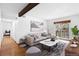 Bright living room with a stylish sofa, modern decor, and sliding glass doors to a balcony at 16359 W 10Th Ave # X6, Golden, CO 80401