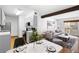 Combined kitchen, dining, and living area with open layout, stainless appliances, and wood floors at 16359 W 10Th Ave # X6, Golden, CO 80401