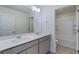 Bathroom featuring double sinks with large mirror and vanity at 13489 Valentia Pl, Thornton, CO 80602