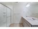 Bathroom featuring double sinks, large mirror, and a glass enclosed shower at 13489 Valentia Pl, Thornton, CO 80602