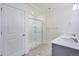 Bathroom featuring double sinks, large mirror, and a glass enclosed shower at 13489 Valentia Pl, Thornton, CO 80602