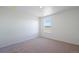 Neutral bedroom featuring carpet, white walls, and a bright window at 13489 Valentia Pl, Thornton, CO 80602