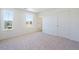 Neutral bedroom with neutral carpet, and two windows at 13489 Valentia Pl, Thornton, CO 80602