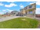 Charming home featuring a front porch, stone accents, well-maintained lawn, and a two-car garage at 13489 Valentia Pl, Thornton, CO 80602