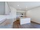 Modern kitchen with gray cabinets, stainless steel appliances, granite counters, and wood-look floors at 13489 Valentia Pl, Thornton, CO 80602