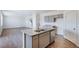 Modern kitchen island with granite countertop, stainless sink, and gray cabinets at 13489 Valentia Pl, Thornton, CO 80602