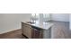 Modern kitchen island with granite countertop, stainless steel sink, and a stainless dishwasher at 13489 Valentia Pl, Thornton, CO 80602