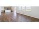 Bright living area featuring hardwood floors, neutral paint, and natural light from sliding glass doors at 13489 Valentia Pl, Thornton, CO 80602