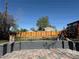Large backyard with new wooden fence and deck with stairs, offering ample outdoor space at 2441 W 55Th Ave, Denver, CO 80221