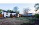 Backyard with a wooden deck, fire pit and space for entertaining with mature trees at 2441 W 55Th Ave, Denver, CO 80221