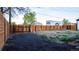 Backyard with a long wooden fence and fire pit at 2441 W 55Th Ave, Denver, CO 80221