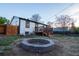 Cozy outdoor living with a brick firepit, perfect for entertaining in this nicely sized yard at 2441 W 55Th Ave, Denver, CO 80221