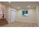 Basement features light wood floors, closet, and stairs to another level at 2441 W 55Th Ave, Denver, CO 80221